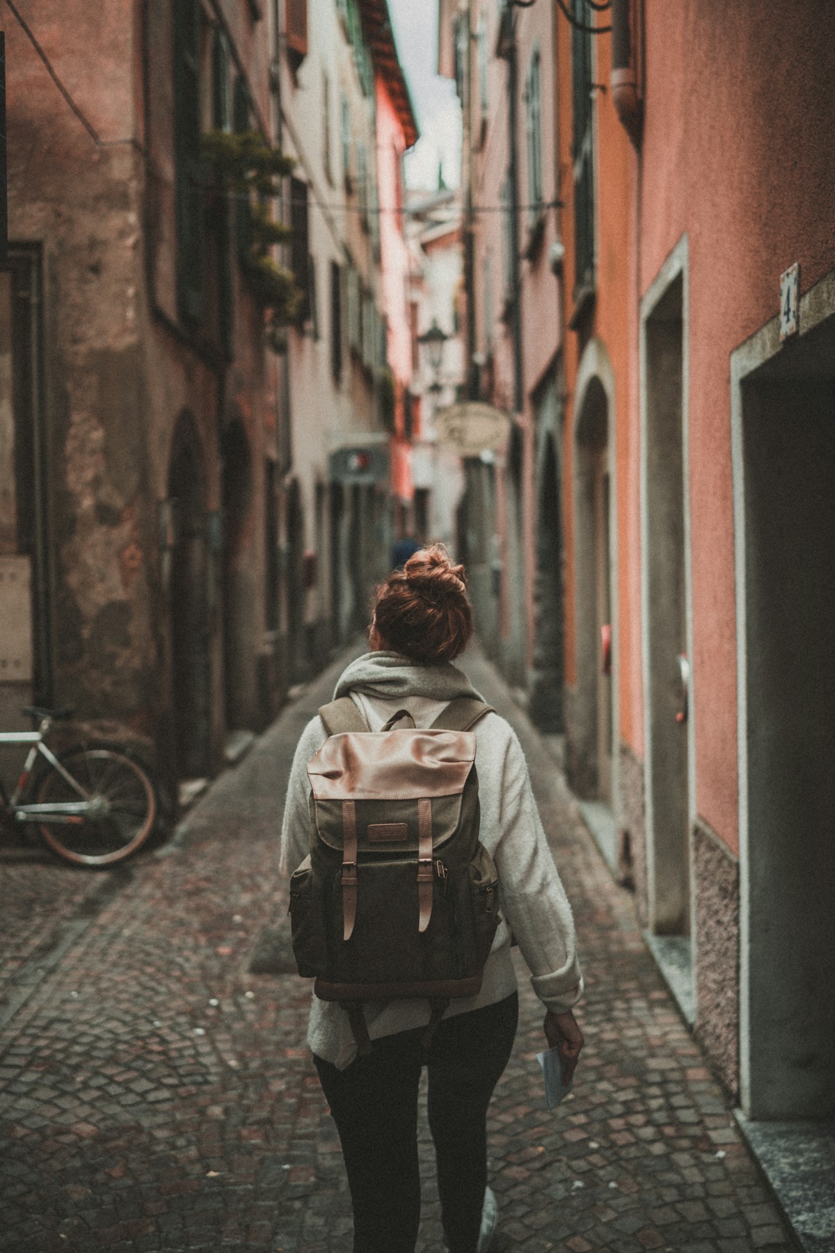 Woman at a train station with a weekender bag ready to travel