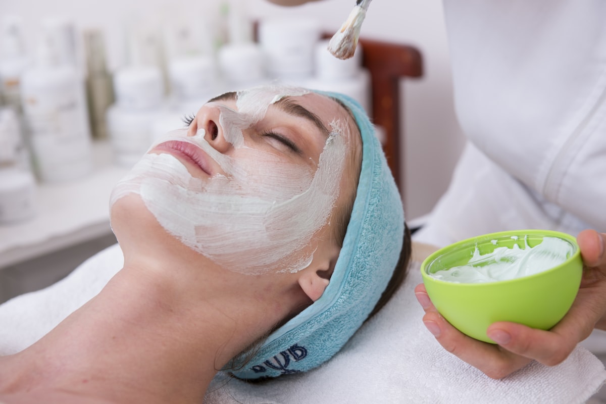 woman receiving professional facial skincare treatment at spa